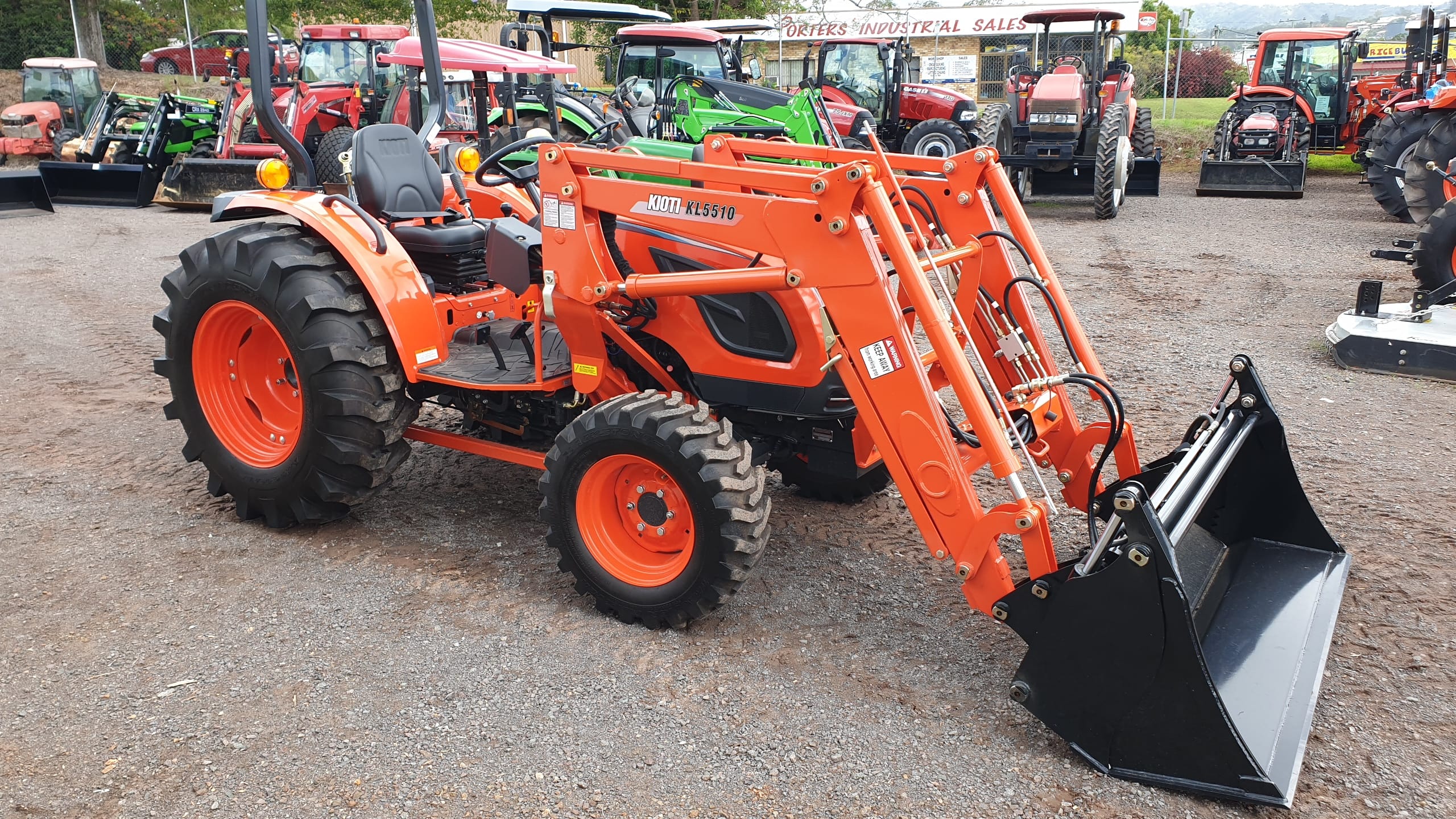 Kioti DK Series side view with loader